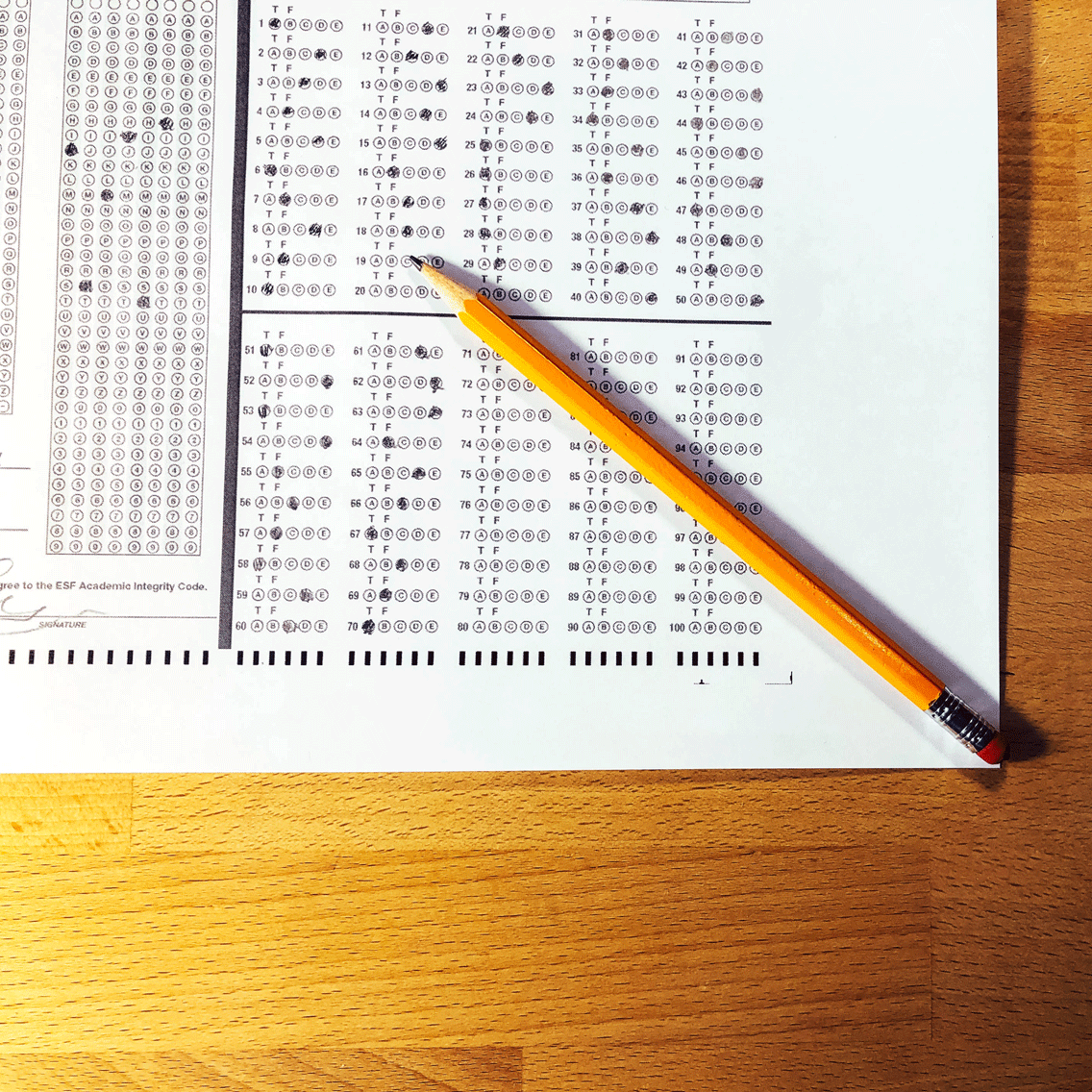 A pencil on top of a scantron
